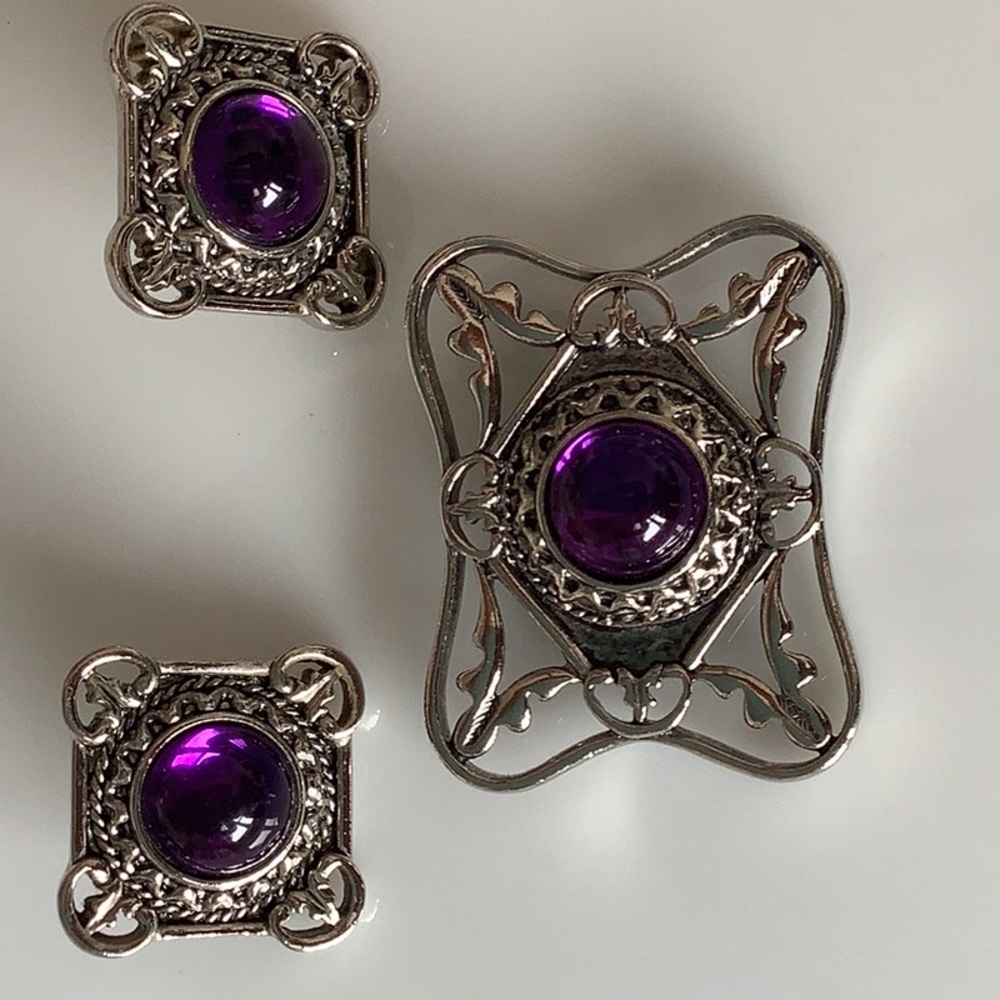 Fun 3 piece earrings and pin. purple glass stone, has  bright appearance.